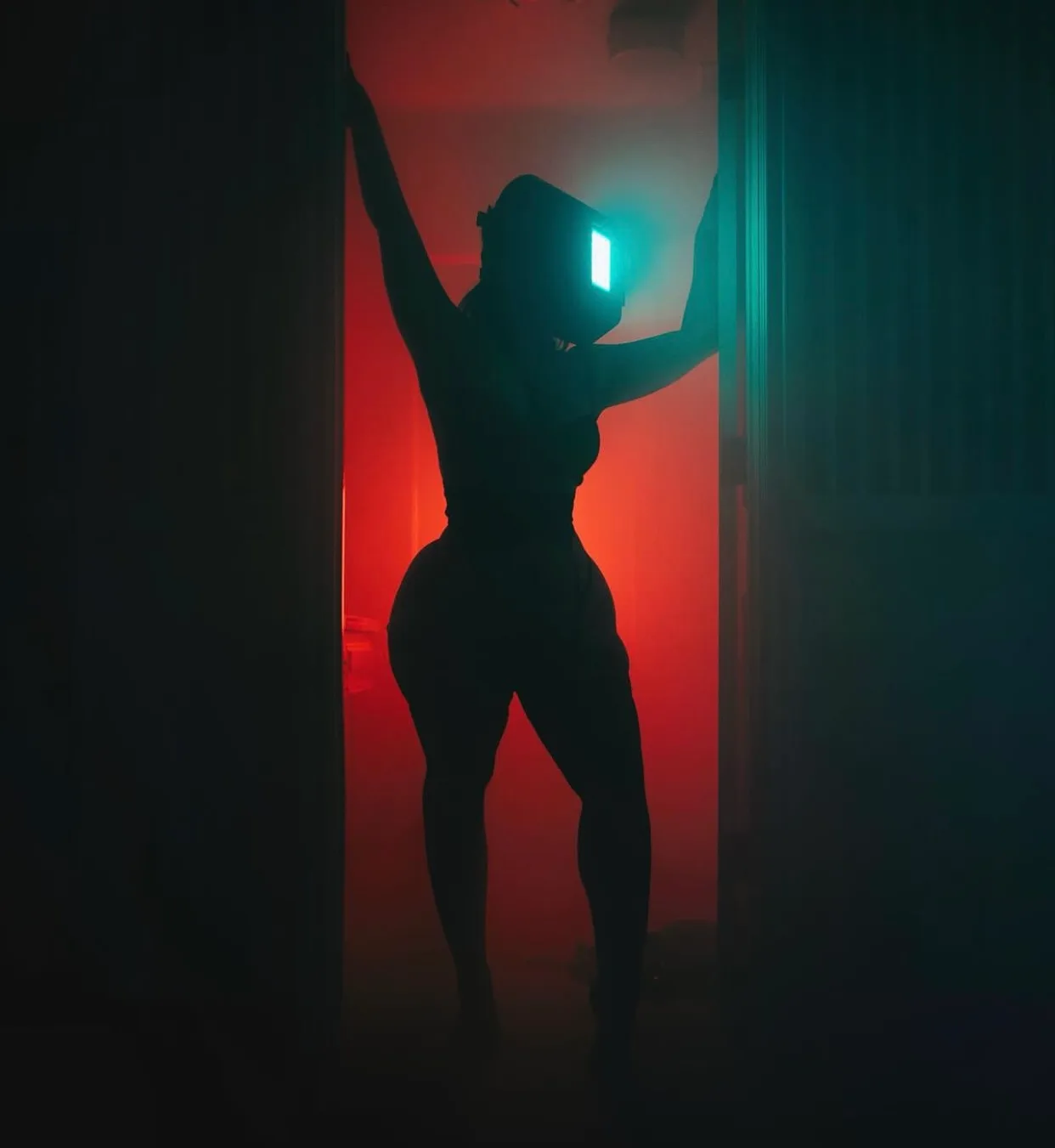 Silhouette of Haley Quinn against red light, YouTube card